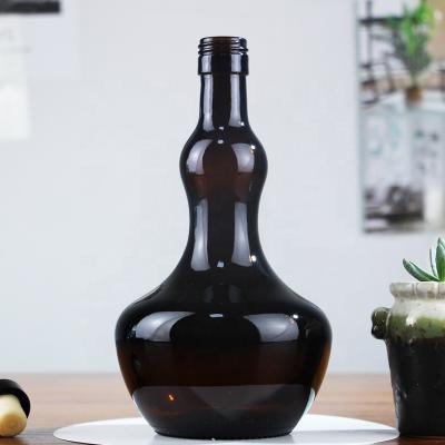 China Unique Wine Shape Primary Color Brown Bottle 750ml Dark Color Glass Screw Cap Bottles For Wine for sale