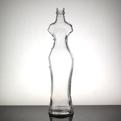 China Sexy Female Liquor Body Shaped Unique Glass Bottle Liquor Bottle With Crown Cap for sale