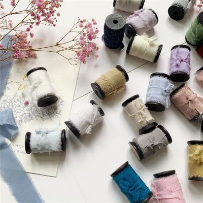 China 20mm-80mm double face crepe fringed edged ribbon by hand made pure silk habotai to wedding packgaed ribbon for sale