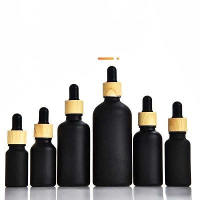 China Hot Selling Personal Care Cosmetic Packaging Essential Oil Bottle Perfume Bottle Dropper Bottle Black Black Glass Cap for sale