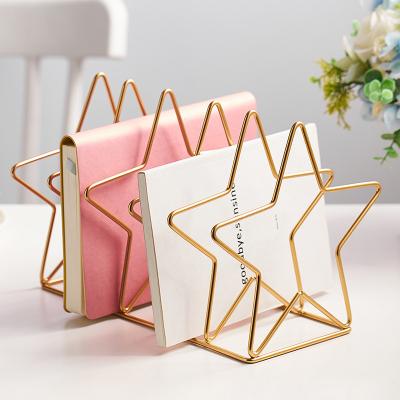 China Morden New Design Nordic Style Mounted Creative Gold Color Iron Book Stand For Desktop Storage Star Shape for sale