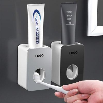 China Viable Home Bathroom Accessories Toothbrush Holder Bathroom Sets Automatic Toothpaste Squeezer Dispenser for sale