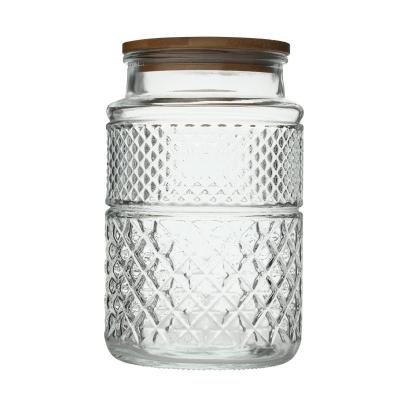 China Wholesale Freshness Preservation Cut Out Embossed Sealed Clear Glass Jar Kitchen Storage Container With Lid for sale