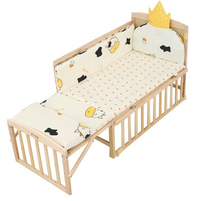 China Modern Multifunctional Foldable Solid Pine Wood Crib Baby Mobile Cradle Splicing Crib With Safety Wheel for sale