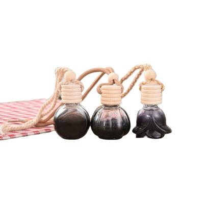 China Refillable Black Skull Shaped Hanging Diffuser Glass Bottle 5ml 8ml 10ml Car Scent Fragrance Perfume Bottle for sale