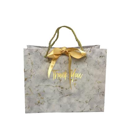 China Recyclable Full Color Marble Effect Recycled Paper Bag With Ribbon Bowknot for sale