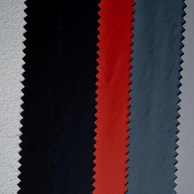 China Waterproof Wax Plain Down Proof Woven Taffeta Nylon Yarn Polyamide Fabrics Roll For Garment Clothing for sale