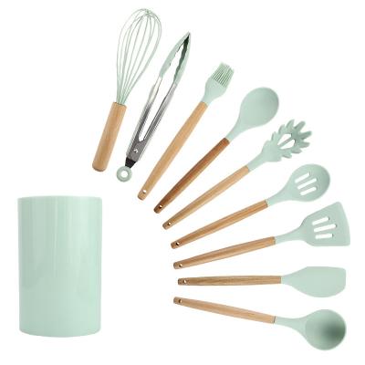 China Sustainable Kitchen Tool 12 Pieces Set Storage Rack Kitchenware Spatula Silicone Cookware Set With Wooden Handle for sale