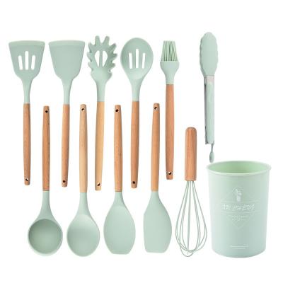 China Viable Most Popular New Design Silicone Soup Spoon Light Green Kitchenware Set With Wooden Handle for sale