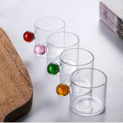 China Sustainable Tea Clear Milk Cup Coffee Drinking Glass Cup With Round Ball Handle for sale