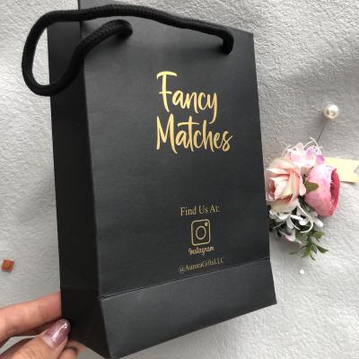 China New Hot Logo Recyclable GOLD Foiled Stamping Black Matte Paper Bag With Custom Logo Cotton Rope Handles For Shopping for sale