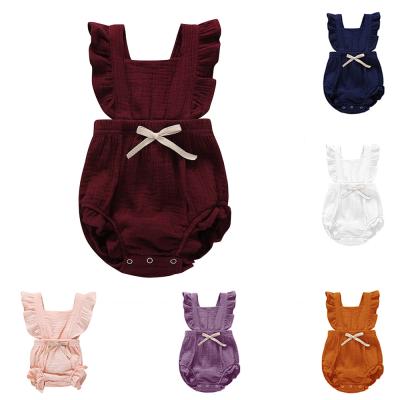 China Comfotable Baby Clothes Solid Color Bow-knot Organic Ruffle Newborn Baby Overalls Summer Clothes Cotton Sleeveless Baby Romper for sale