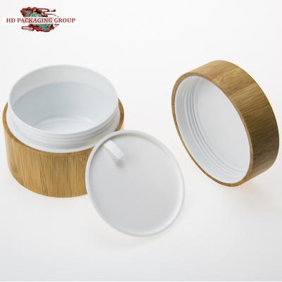 China Household products wholesale 50g pp plastic jar with bamboo lid eco-friendly empty cream packaging container for sale