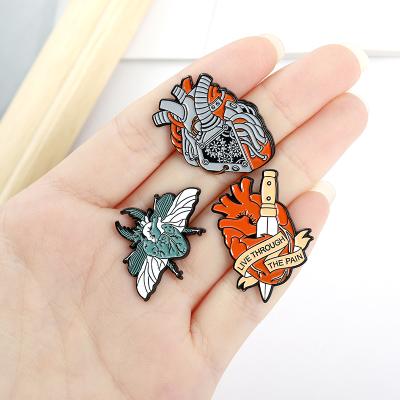 China Custom Europe Organ Heart Mite Dagger Brooch Live Through The Pain Enamel Pins for sale