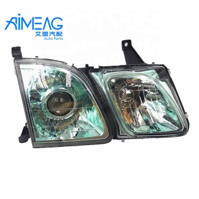 China Directed to LX470 Headlight Green Bottom Plastic Glass LX470 Outer Headlights for sale