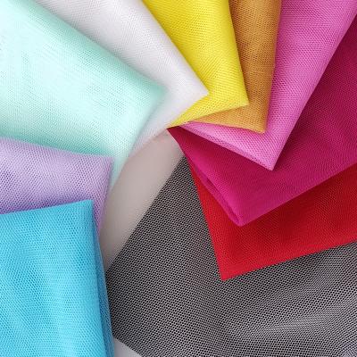 China Fluorescent hexagonal polyester mosquito net mesh fabric with many colors in stock for dress for sale