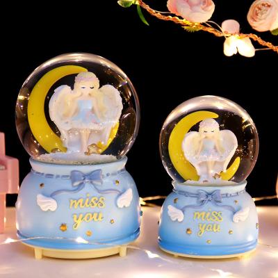 China 2023 New Moon Angel Crystal Ball Music Snowflake Colorful Light National Dress Bedroom Music Box Children Gift for sale