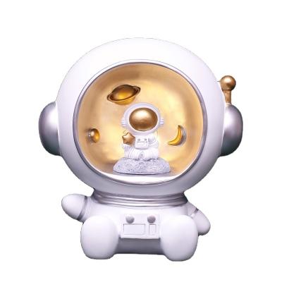 China Kids Gift Handmade Cute Creative Coin Led Astronaut Ornaments Coin Storage Box Cartoon Astronaut Piggy Bank for sale