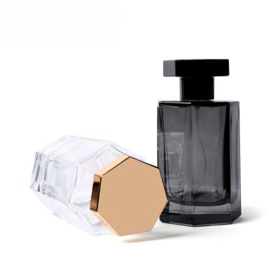 China 100ml Cosmetic Empty Perfume Bottle Glass Hexagonal Transparent Black White Colored With Cap for sale