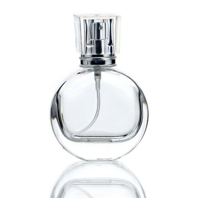 China Cosmetic Refillable Empty Perfume Bottles 30ml Flat Round 30ml Clear With Gold Silver Spray for sale