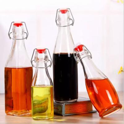 China 150ml 250ml 500ml 1000ml Round Shape Wine Whiskey Glass Bottle Swing Top Empty Wine Bottles for sale