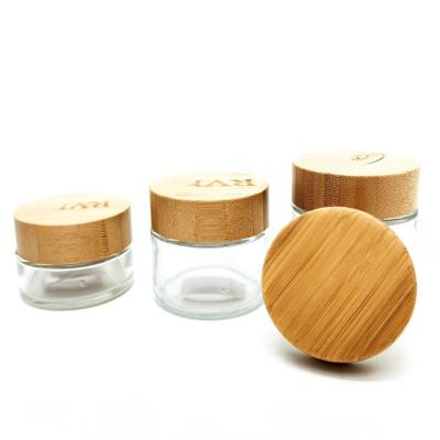 China Empty Eco-friendly Cosmetic Packaging Frosted Clear Skincare Glass Cream Jar With Child Resistant Bamboo Lid for sale