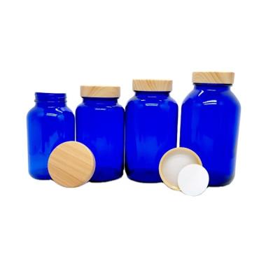 China 400ml 500ml Tall Chemical Blue Empty White Glass Food Grade Apothecary Pharmaceutical Pill Bottle With Grain Plastic Wood Lid for sale