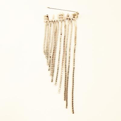 China New Design Fashionable Luxury Gold Plated Crystal Letter Fringe Brooch For Coat Suit for sale