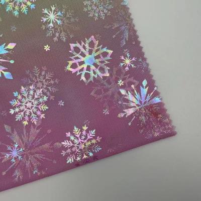 China Sustainable paper printed with soft 100% polyester foil snowflake design knit mesh fabric for dress for sale