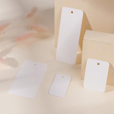 China High-grade white thickened cardboard white thickened cardboard clothing label jewelry lighting shoe cap label underwear label papercard for sale