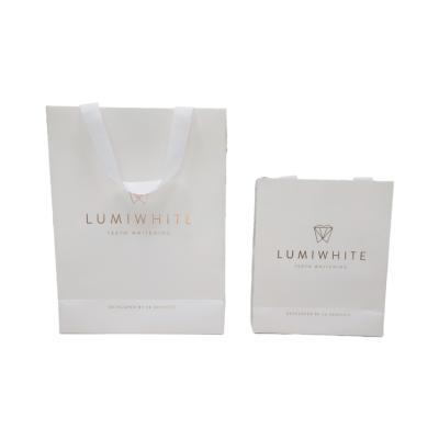 China Luxury Handmade Eco Friendly White Kraft Tote Shopping Paper Bag with Smooth Touch Laminated Grosgrain Ribbon Finish Handle for sale