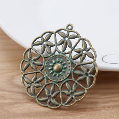 China FASHIONABLE Patina Green Metal Verdigris Flower Hollow Round Large Charms Pendants For Necklace Jewelry Making 47x44mm for sale