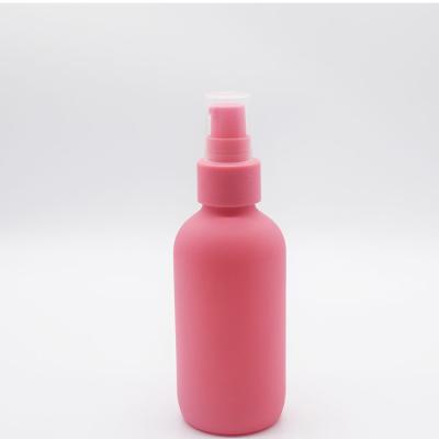 China Personal Care 120ml 60ml Round Shape Treatment Pump Serum Pink Glass Bottle for sale