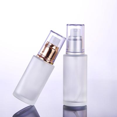 China 30ml 50ml 60ml 100ml luxury popular clear frosted flat shoulder glass lotion pump bottle for skin care for sale