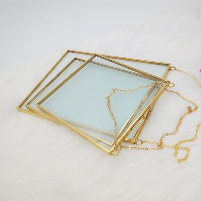 China HOME DECORATION Double Sided Hanging Floating Sight Glass Self Holder Pressed Glass Brass Gold Floating Photo Frame for sale