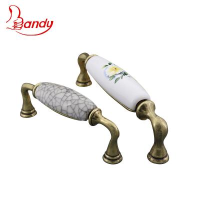 China Modern Classic Popular Ceramic Zamak Leg Split Pattern Race Zamak Leg Customized Buffet Cupboard Wardrobe Pull Handles for sale