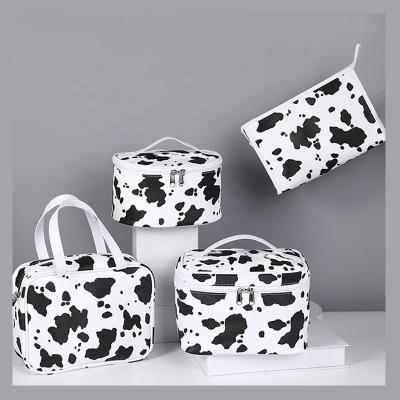 China Fashion Custom LOGO Private Label Tending Large Cowhide Designer Travel Cosmetic Pouch Black And White Makeup Bag for sale