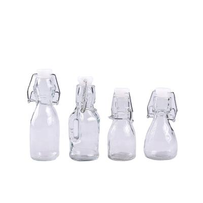 China Reusable Mini Glass Bottle Glass Jar Beverage Swing Top Brewing Bottle with Cap for Jelly Beans, Drinks, Liquid for sale