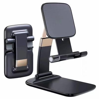 Cina Flexible Gravity Mini Folding Stand Suitable of New Adjustable Zinc Alloy Foldable Desktop Phone Holder for iPad Mobile Phone in vendita