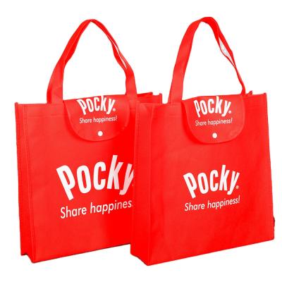 China 100gsm Eco Friendly Reusable Red Non Woven Folding Bag Handled Heavy Duty For Promotion for sale