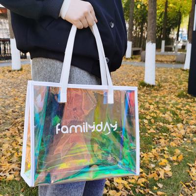 China Custom Handled Activity Gift Bag Colorful Gift Bag Custom PVC Bags Handy Laser Christmas Party Shopping Bag for sale