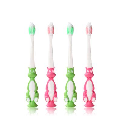 China Food Grade Low Holder Manual Suction Handle Cartoon Dinosaur Children Non-slip Toothbrush for sale