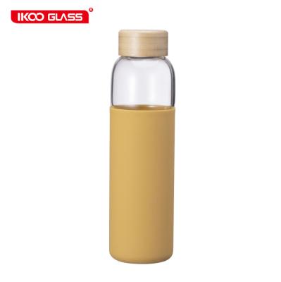 China Top Selling Sustainable Hot Amazon Borosilicate Colored Glass Water Bottle With Bamboo Lid for sale