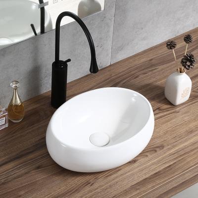 China Modern Above Counter Mounting Small Size One Piece Ceramic Hand Wash Basin for sale