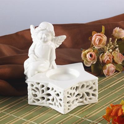 China Home Decor Wedding Home Decor Hollow-Carved Holders Chic Angel Candlestick Ceramic Candle Holder for sale