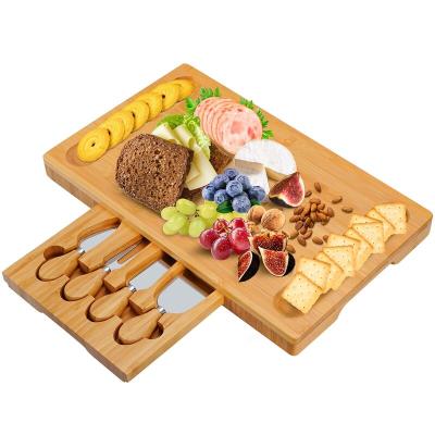 China Amazon Sustainable Hot Custom Wooden Bamboo Cheese Board Set With Cutlery In Slide Out Drawer Cheese Tray Cutting Board for sale