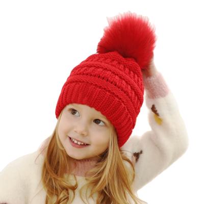 China 2020 Wholesale COMMON acrylic knit custom winter kids beanie hats winter hats with faux fur pom poms for sale