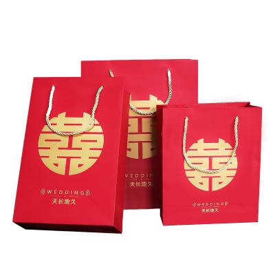 China Materials Toughness Light Red Gold Good Stamp Wedding Gift Recycled Coated Paper Paper Bag for sale