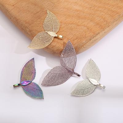 China Natural Vintage Factory Direct Selling Plating Gold Cutting Sapling Leaf Earrings Whale Tail Jewelry Accessories Supplies for sale