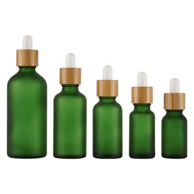 China Wholesale Cosmetic 5ml 10ml 15ml 20ml 30ml 50ml 100ml Frosted Essential Oil Bottle Green Customized Glass Bottle With Dropper for sale